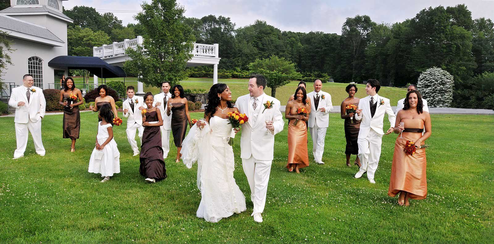 a bride and groom are walking with their wedding party after major photo retouching