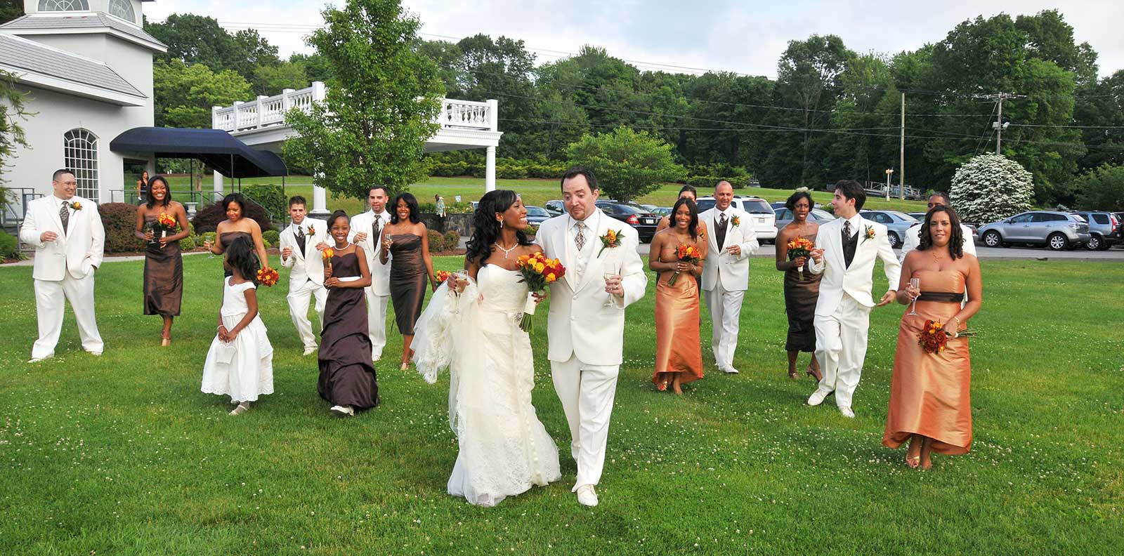 a bride and groom are walking with their wedding party before major photo retouching