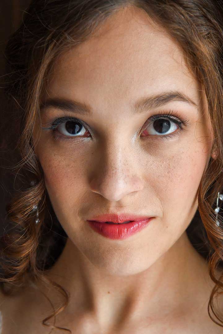 A close up of a bride's face with red lips and freckles wedding photographed by Rogers Photography in Connecticut.