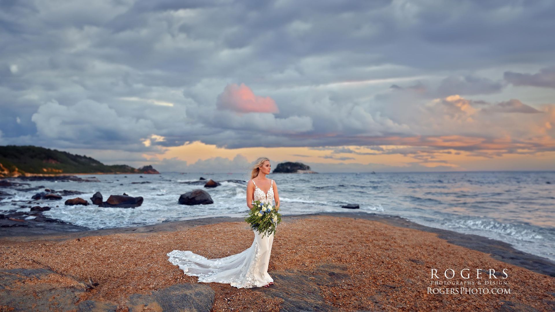 A bride in a wedding dress is standing on the beach at Madison Beach Hotel wedding photographed by Rogers Photography in Connecticut.