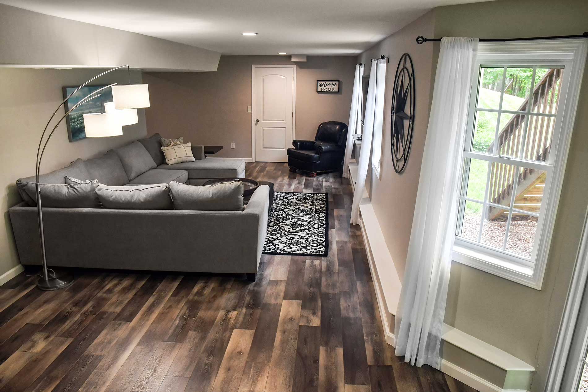 A living room with hardwood floors and a couch for Real Estate photography by Rogers Photography.