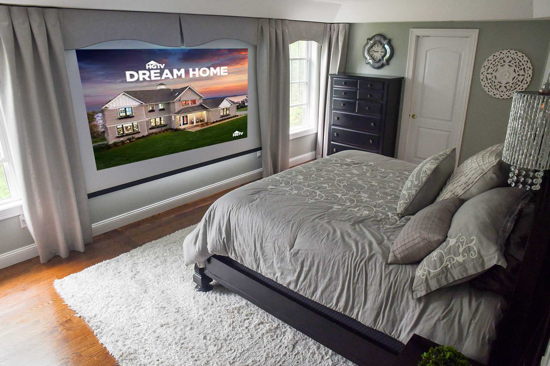 A bedroom with a projector screen that says dream home for Real Estate photography by Rogers Photography.