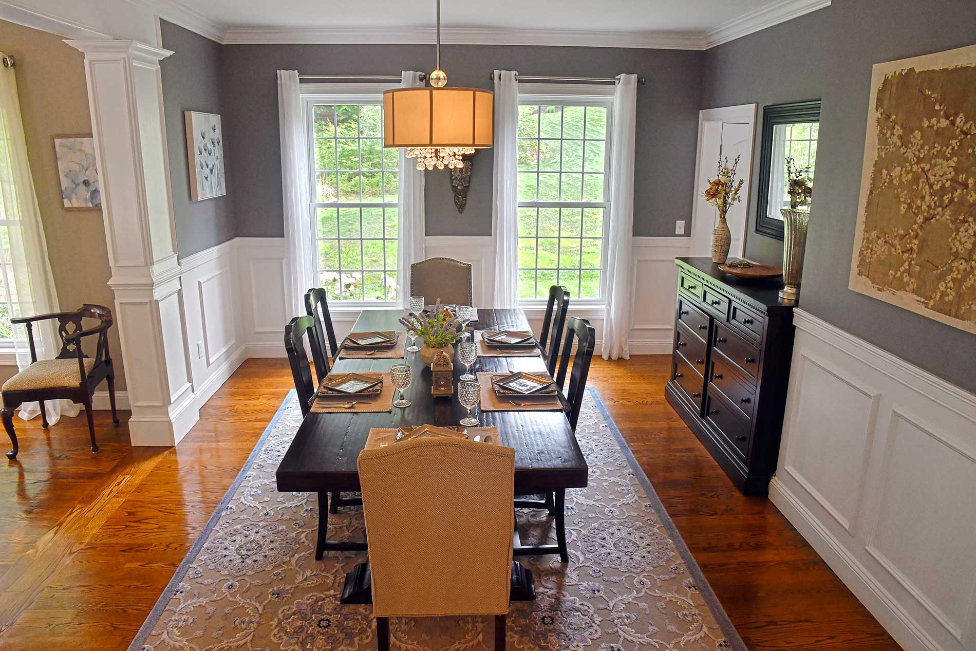 A dining room with a long table and chairs for Real Estate photography by Rogers Photography.