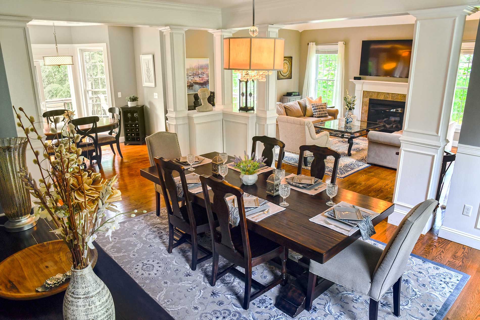 A dining room with a table and chairs and a fireplace for Real Estate photography by Rogers Photography.