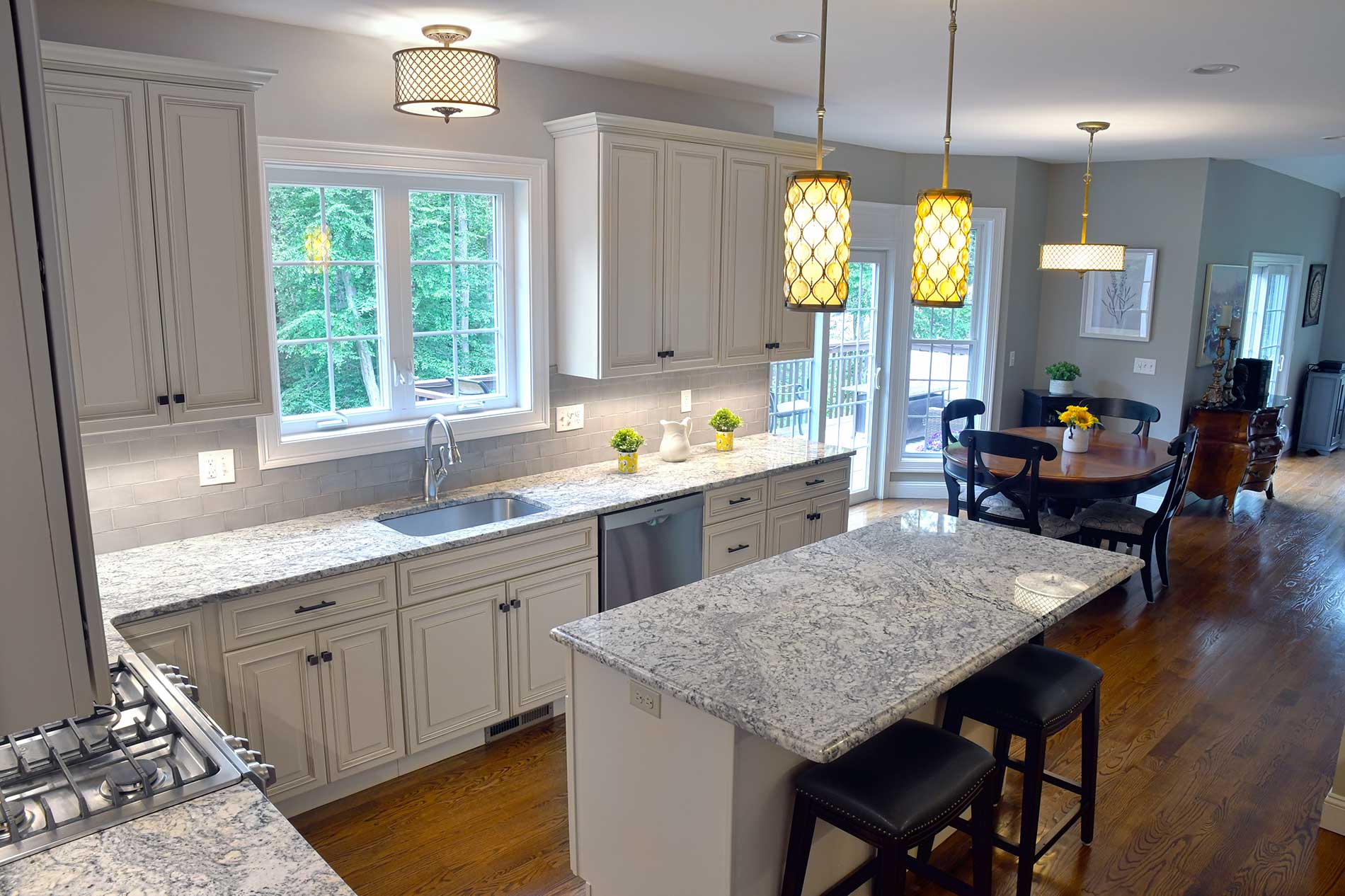 A kitchen with granite counter tops and white cabinets for Real Estate photography by Rogers Photography.