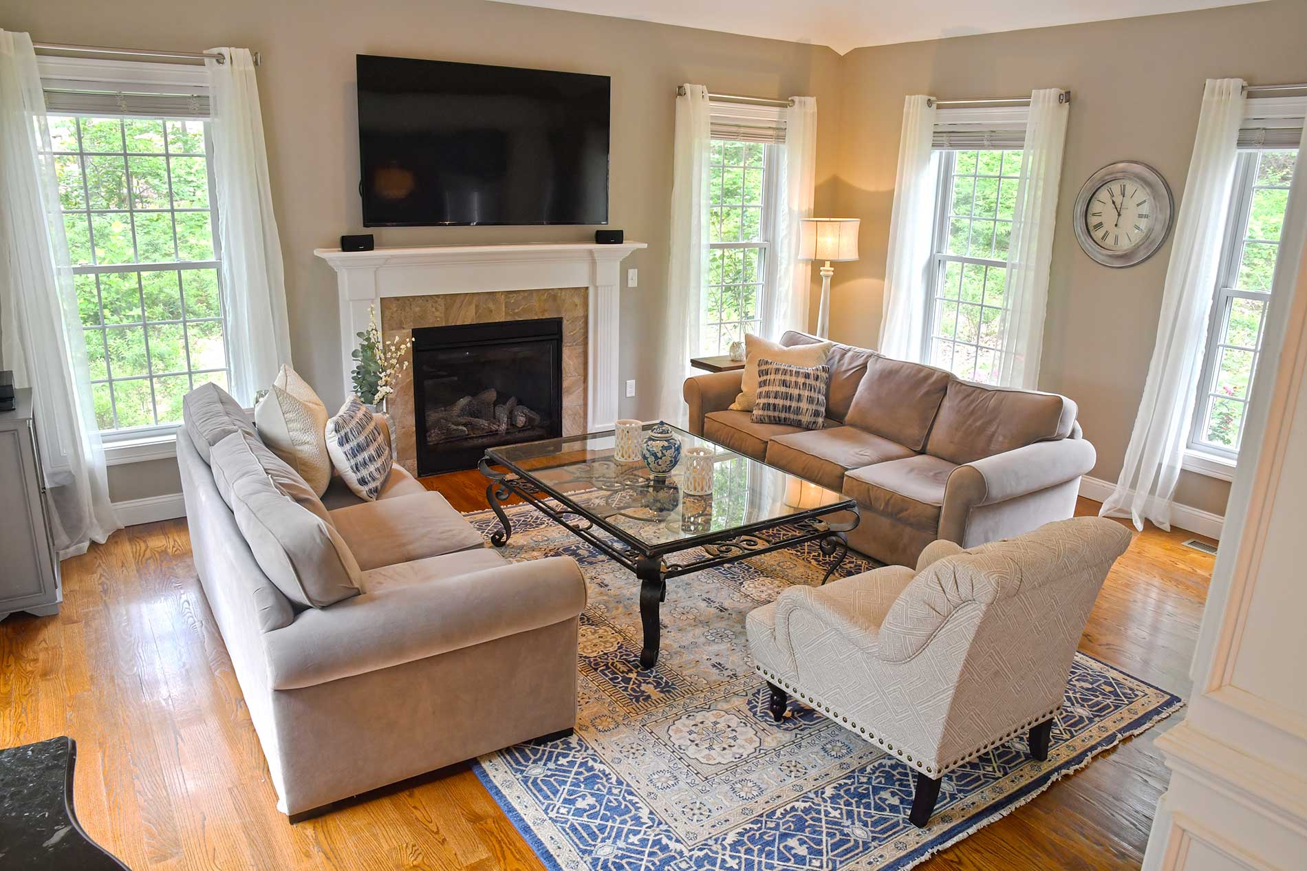 A living room with a fireplace and a flat screen tv for Real Estate photography by Rogers Photography.