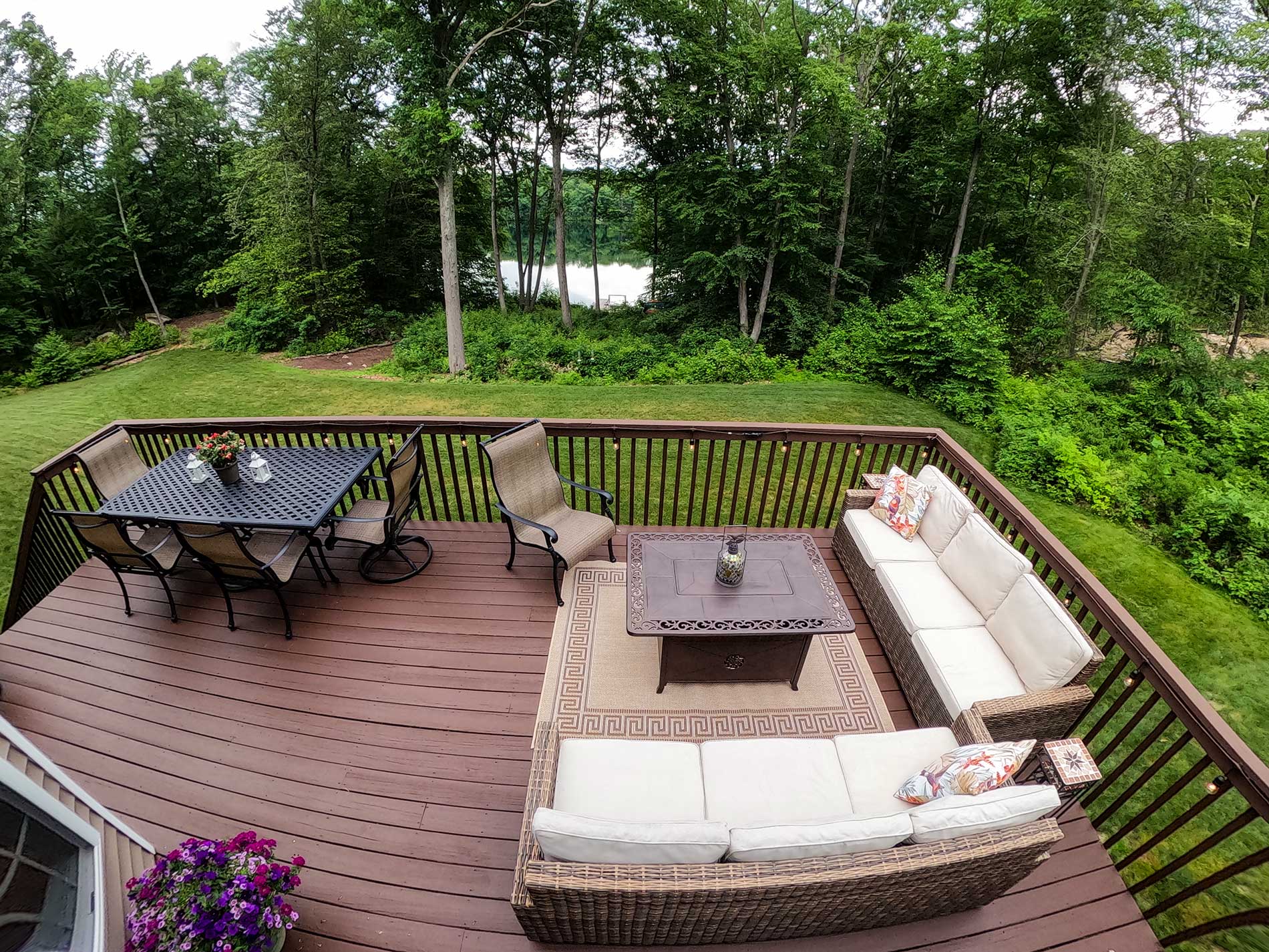 An aerial view of a deck with furniture and a table for Real Estate photography by Rogers Photography.