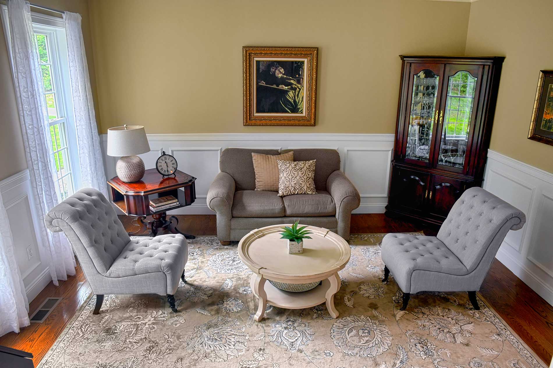 A living room with a couch two chairs and a coffee table for Real Estate photography by Rogers Photography.