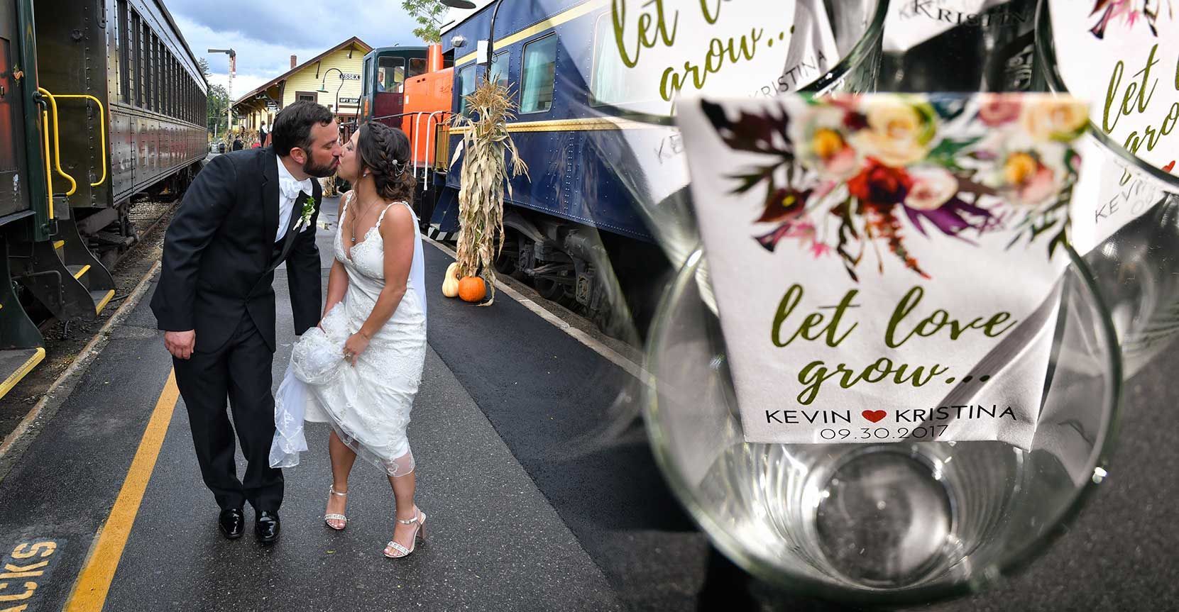 A bride and groom kiss in front of a train with a sign that says let love at Essex Steam Train wedding photography by Connecticut Wedding Photographers Rogers Photography.