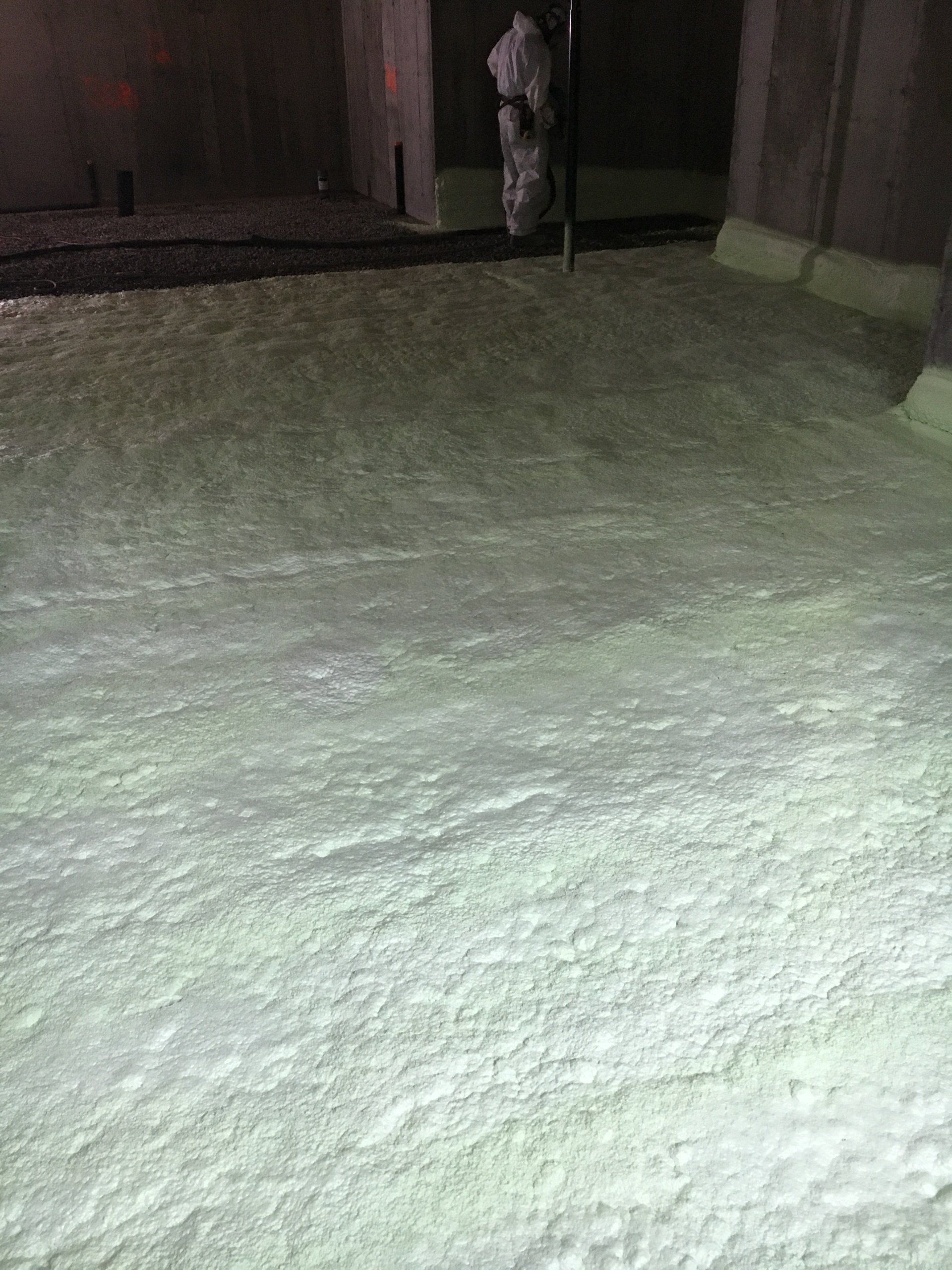 A large amount of white foam is covering the floor of a building.