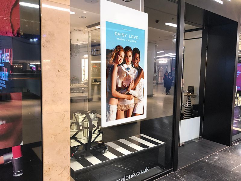 a store window with a picture of three women on it 