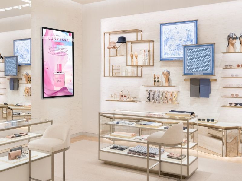 a display case in a store with a sign on the wall