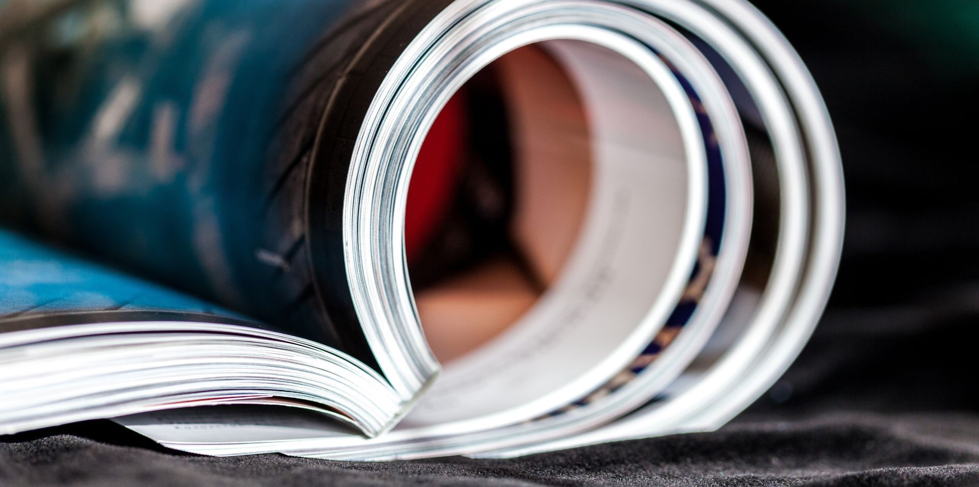 A close up of a rolled up magazine on a table.
