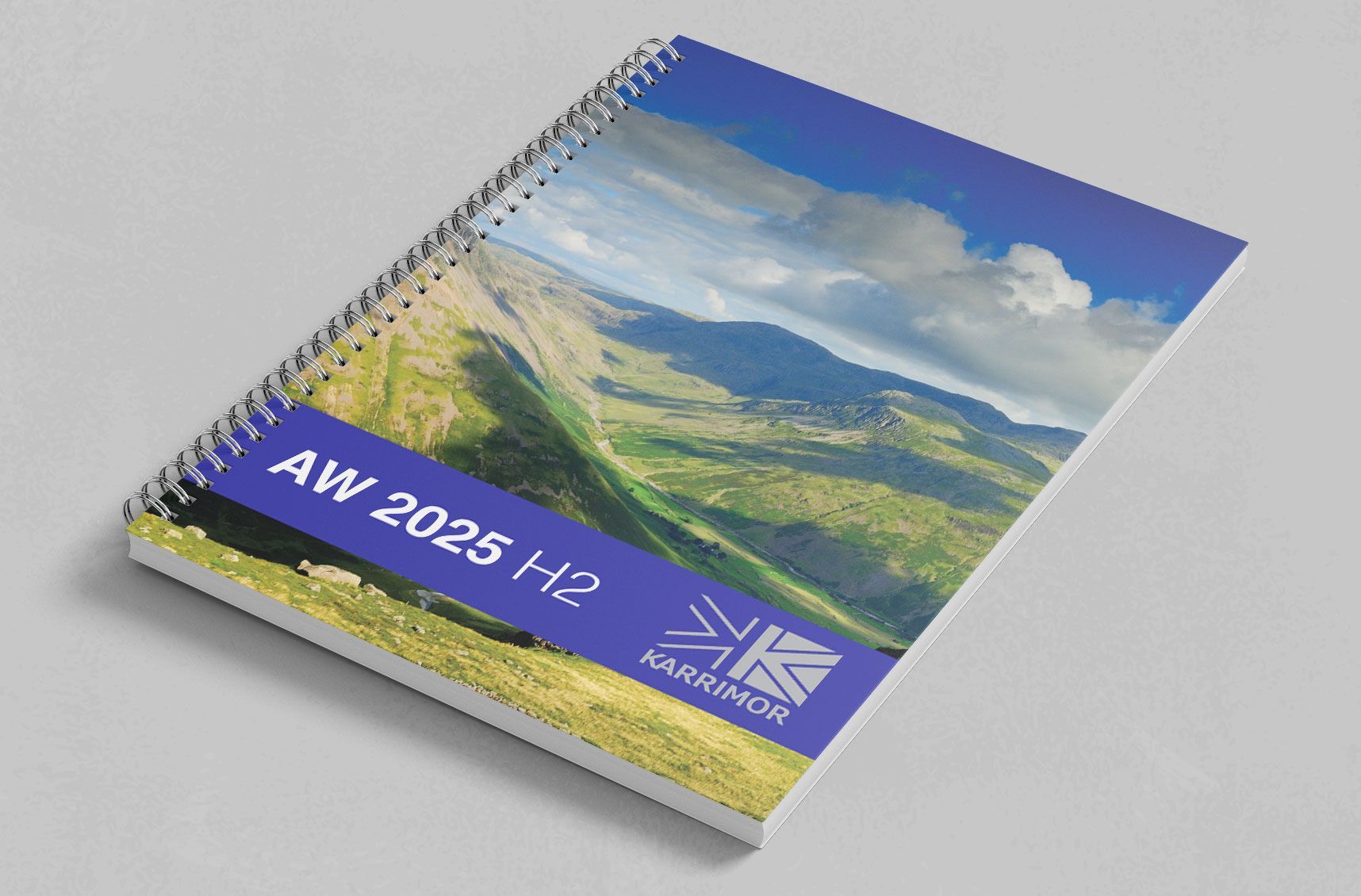 A spiral bound catalgue with a picture of a lush green valley