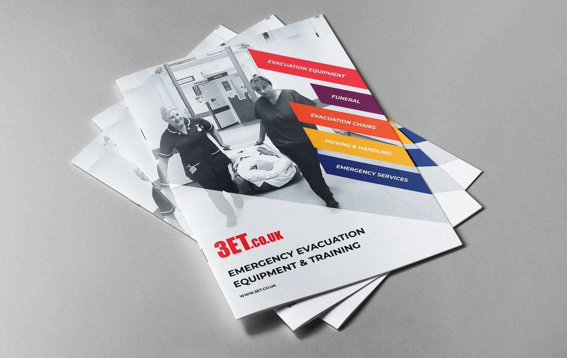 Brochure stack featuring emergency evacuation equipment & training, showing people assisting another.