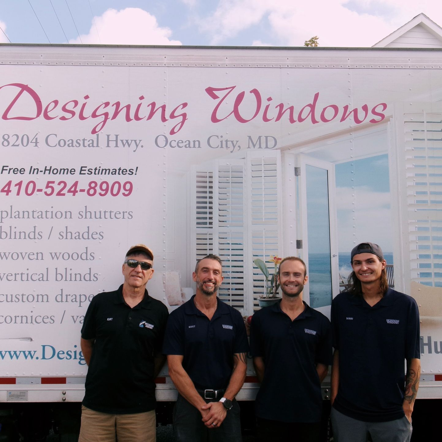 Installers at Designing Windows smiling and standing in front of branded truck