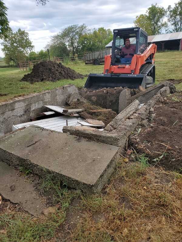A man is driving a bulldozer in a field.