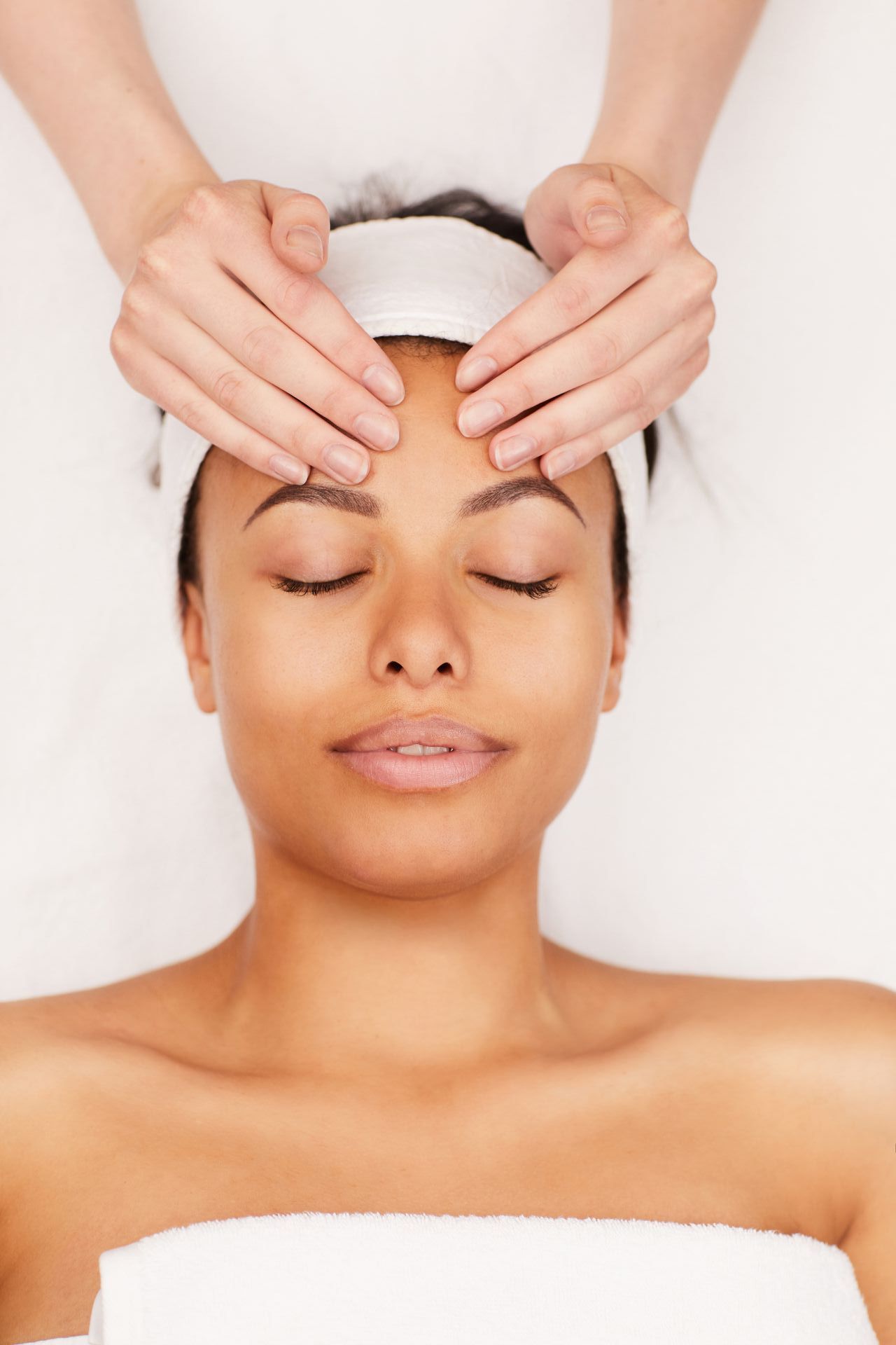 A woman is getting a facial treatment at a beauty salon.