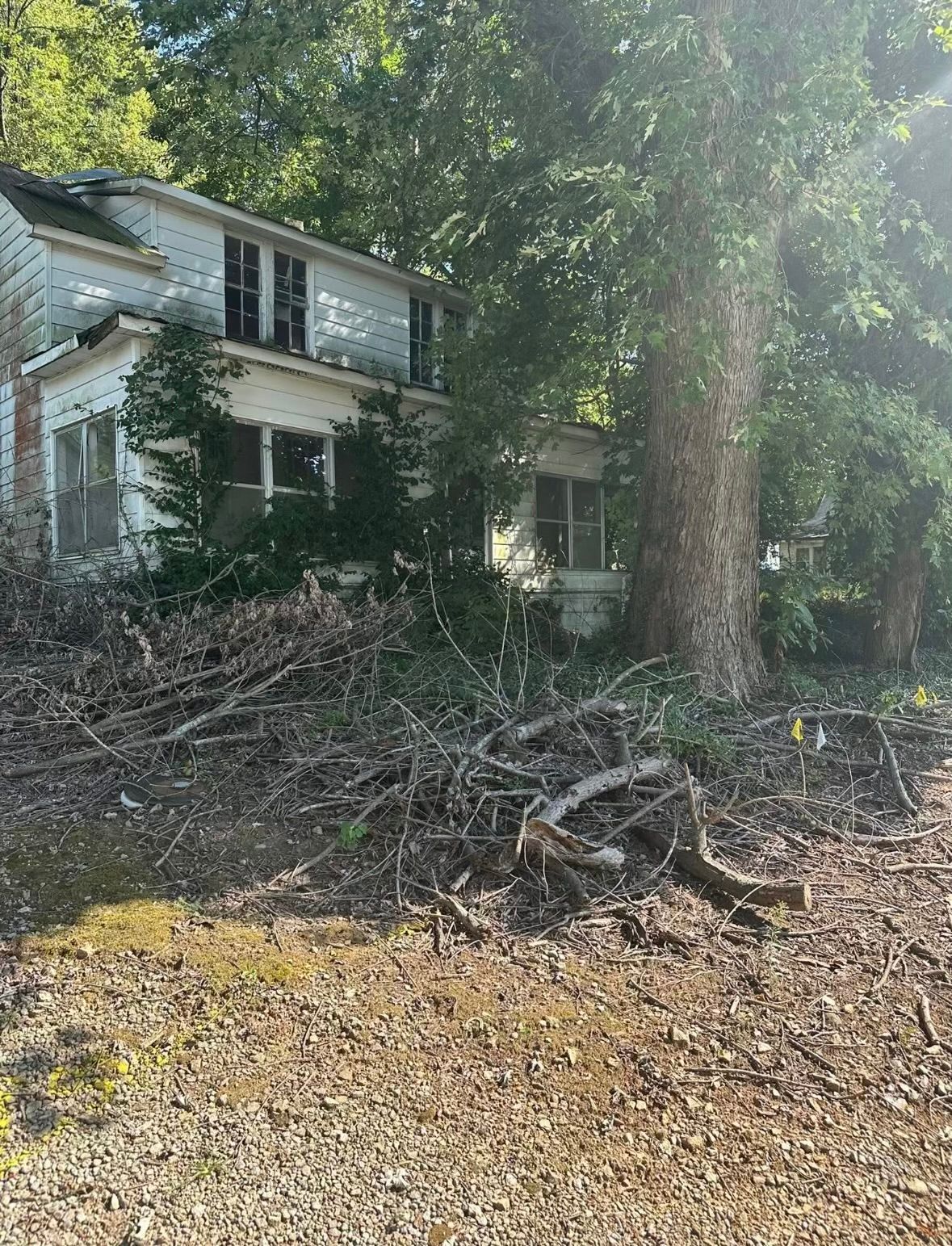 A house is sitting on top of a hill surrounded by trees.