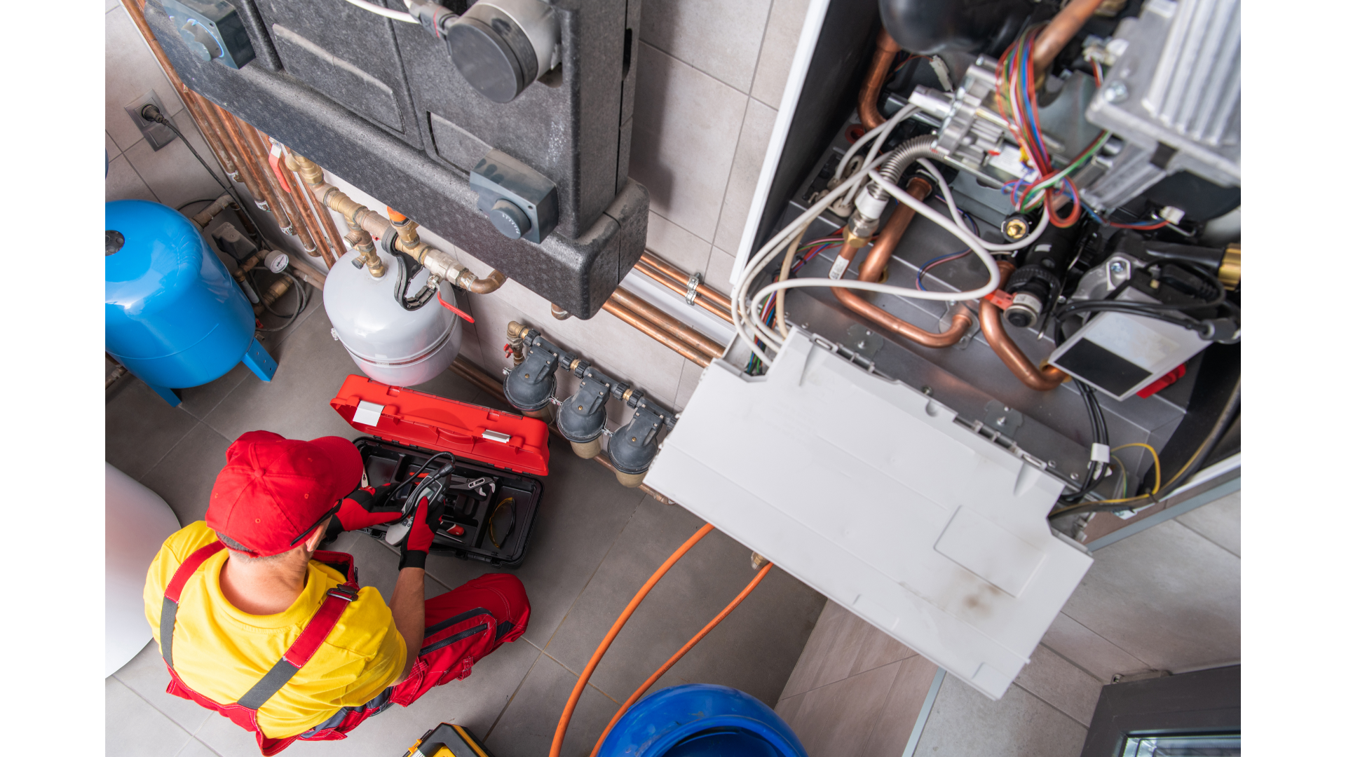A man is working on a heating system in a room.
