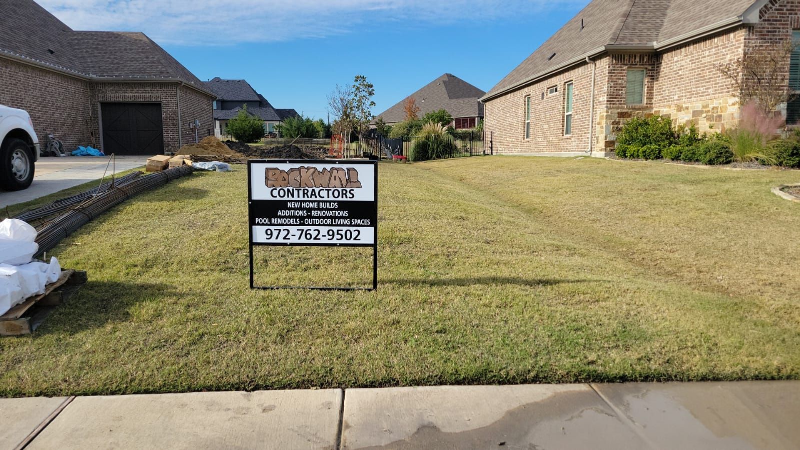 A yard with a sign in the middle of it