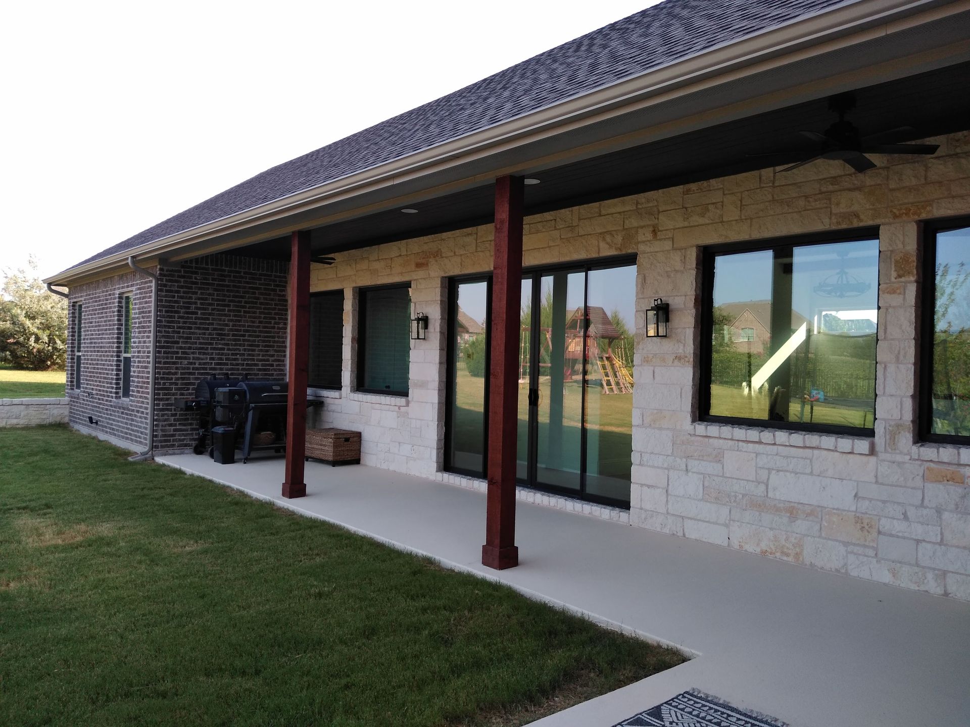 A house with a covered porch and sliding glass doors