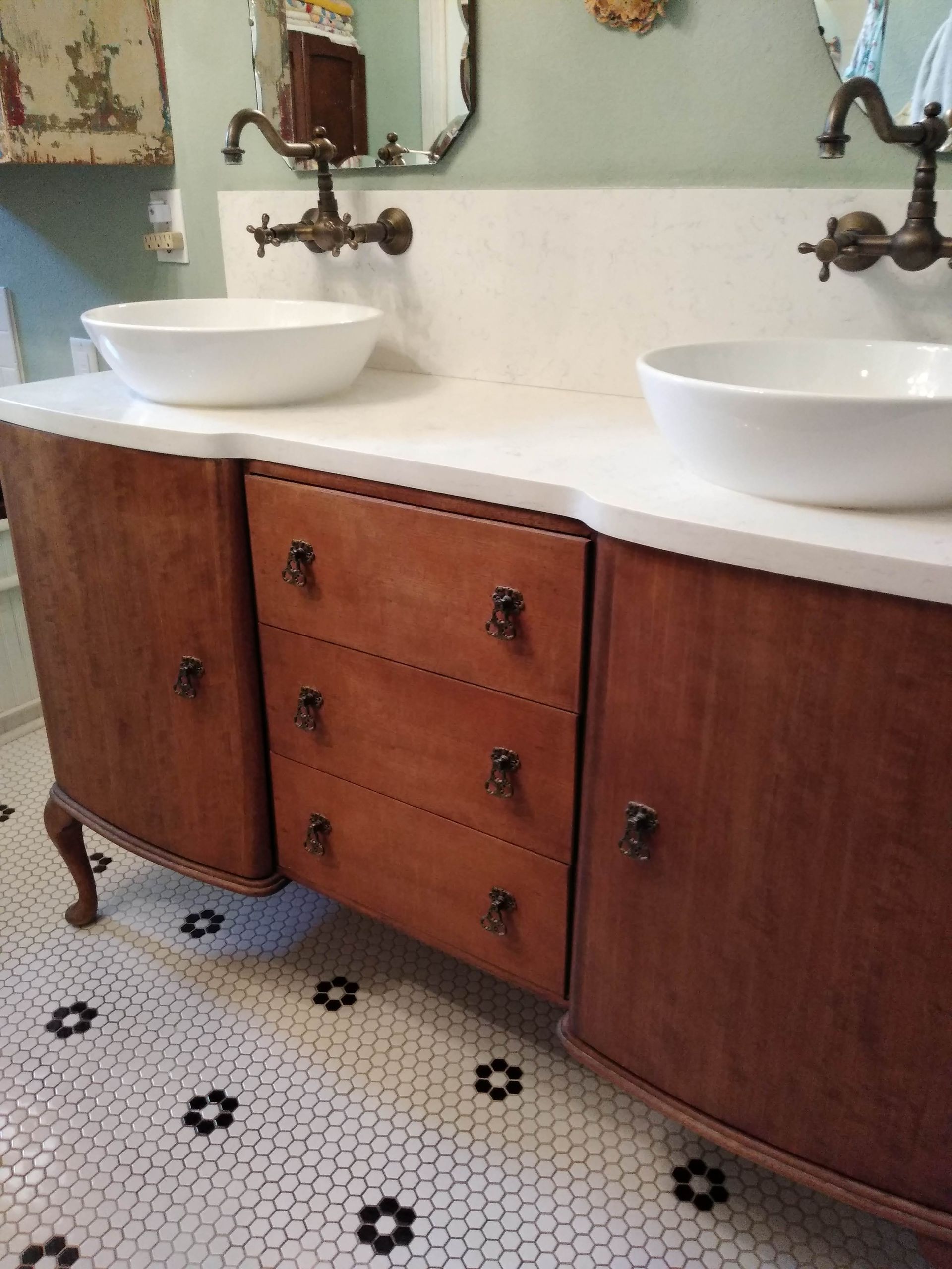 A bathroom vanity with two sinks and a mirror