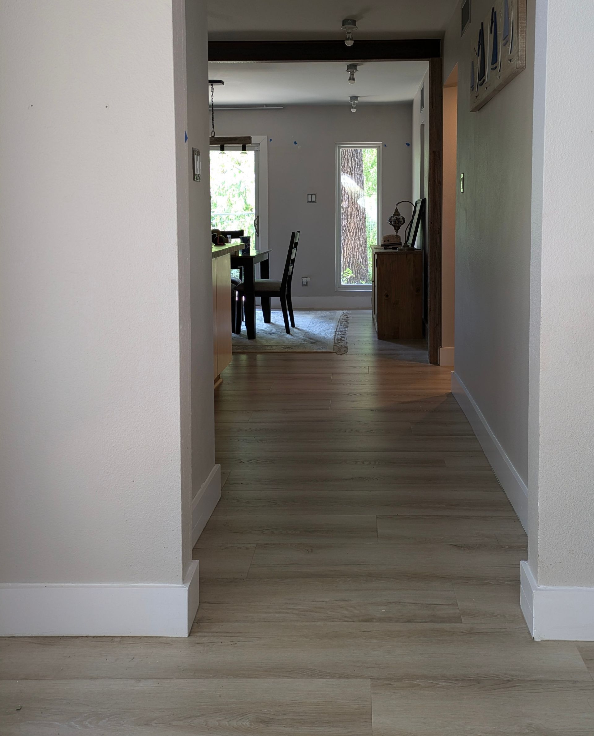 A hallway leading to a living room and dining room