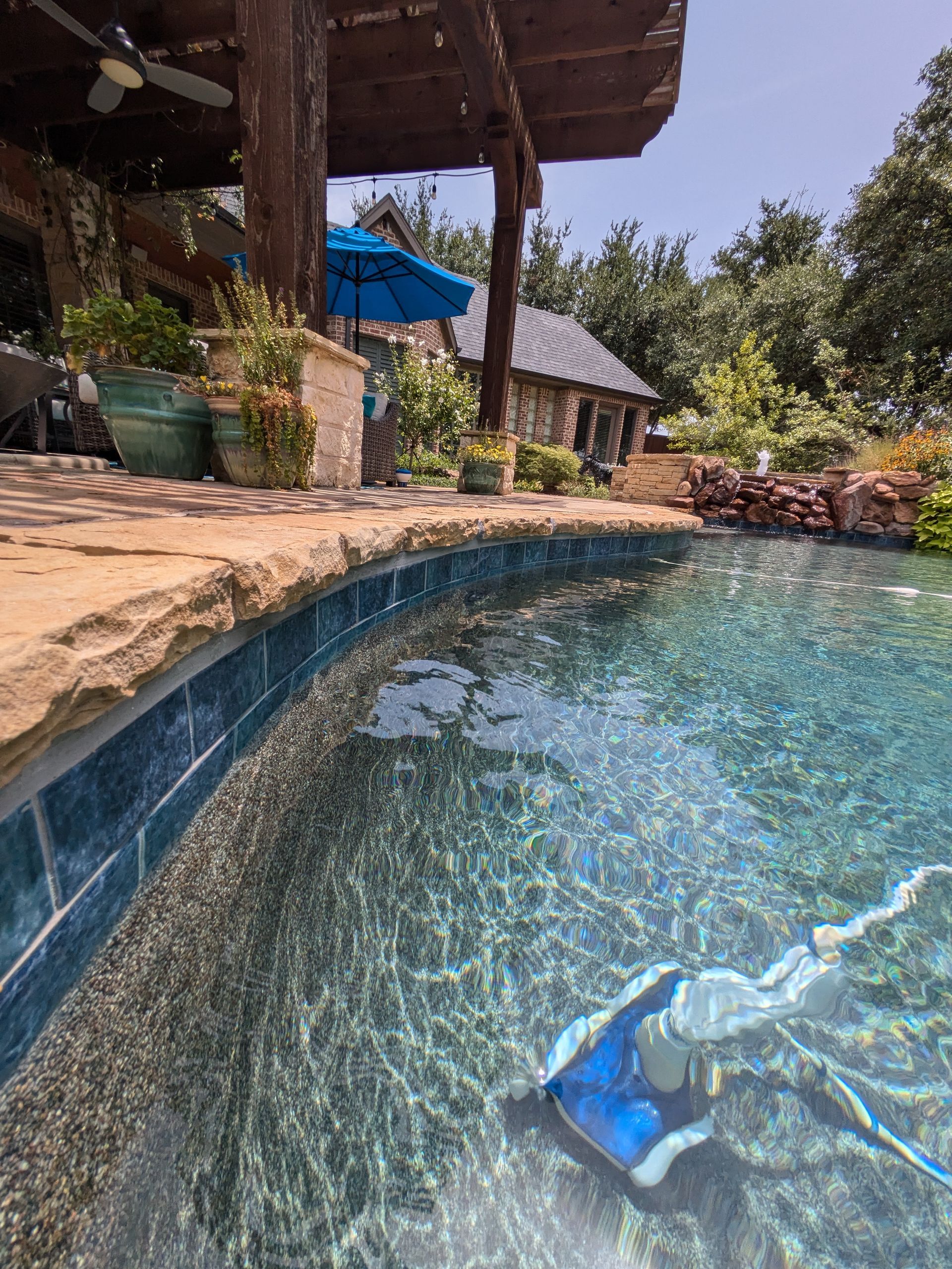 A robotic pool cleaner is cleaning a swimming pool.