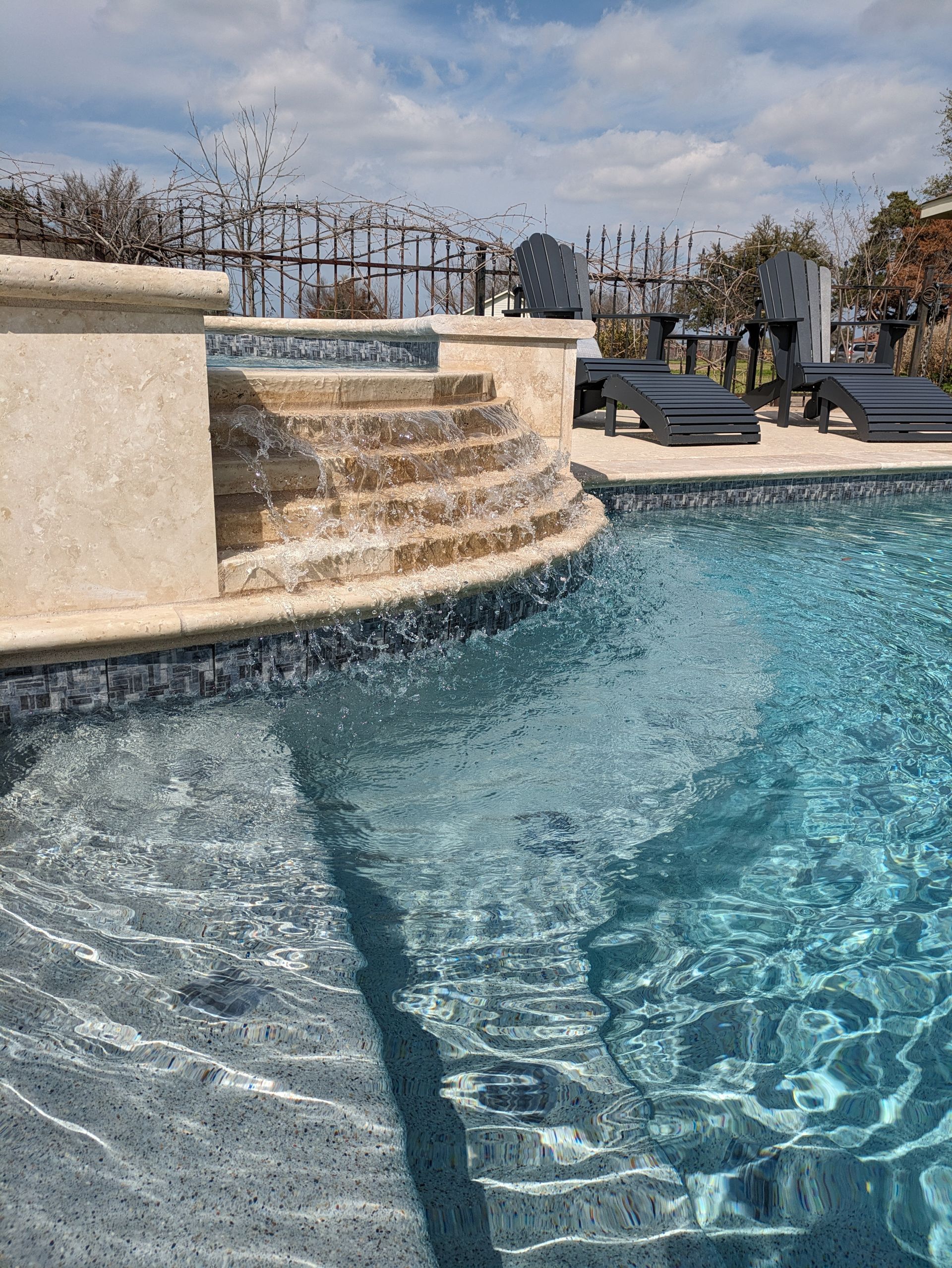 A large swimming pool with stairs leading up to it