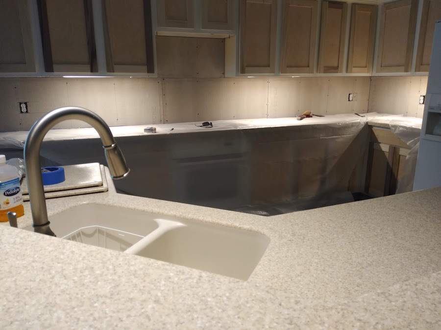 A kitchen with a sink and a faucet in it