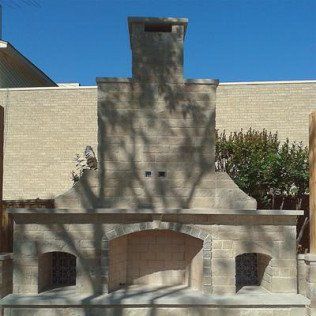 A brick fireplace is built into the side of a building.