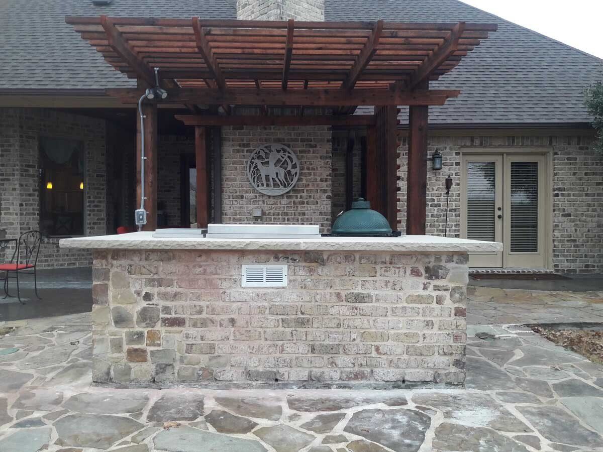 A brick building with a wooden pergola over it
