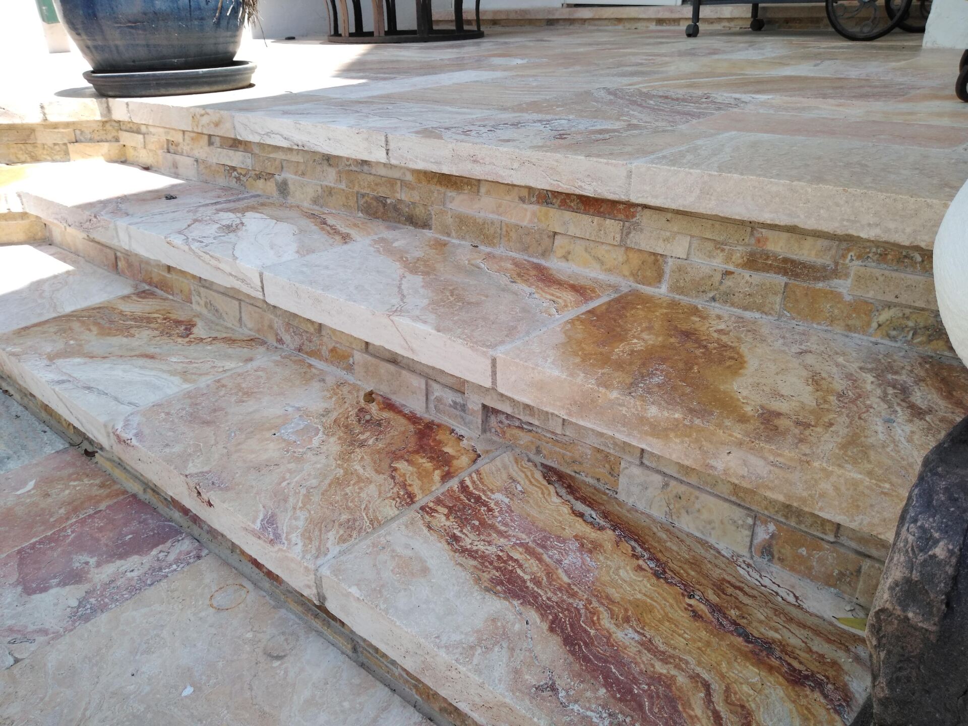 A set of stone stairs leading up to a porch.