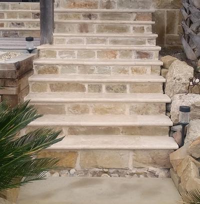 A set of stone stairs leading up to a house.
