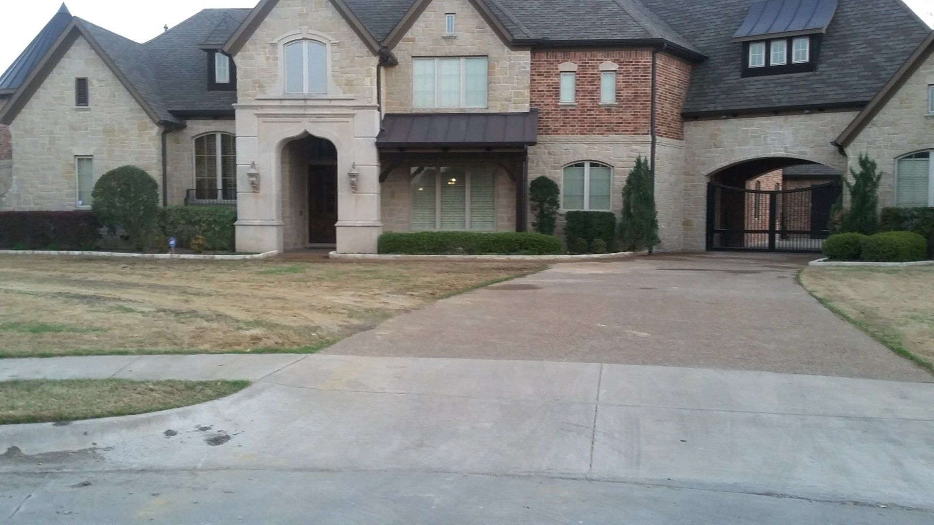 A large brick house with a driveway in front of it