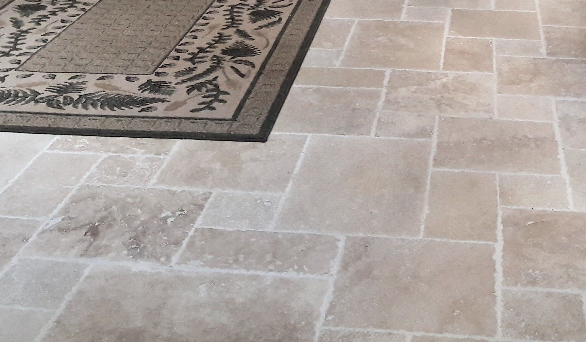 A rug is sitting on a tiled floor next to a rug