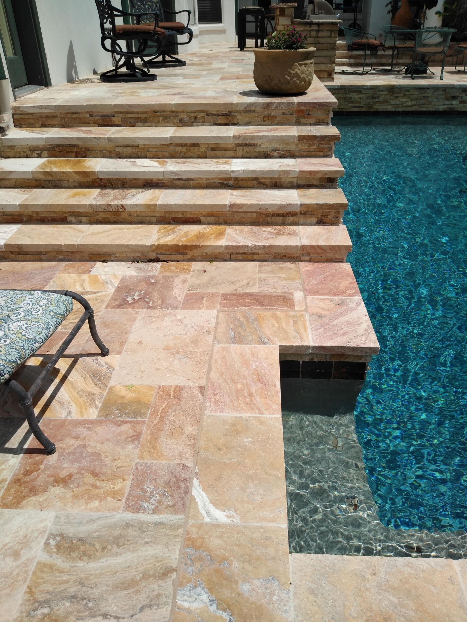 A swimming pool with stairs leading up to it