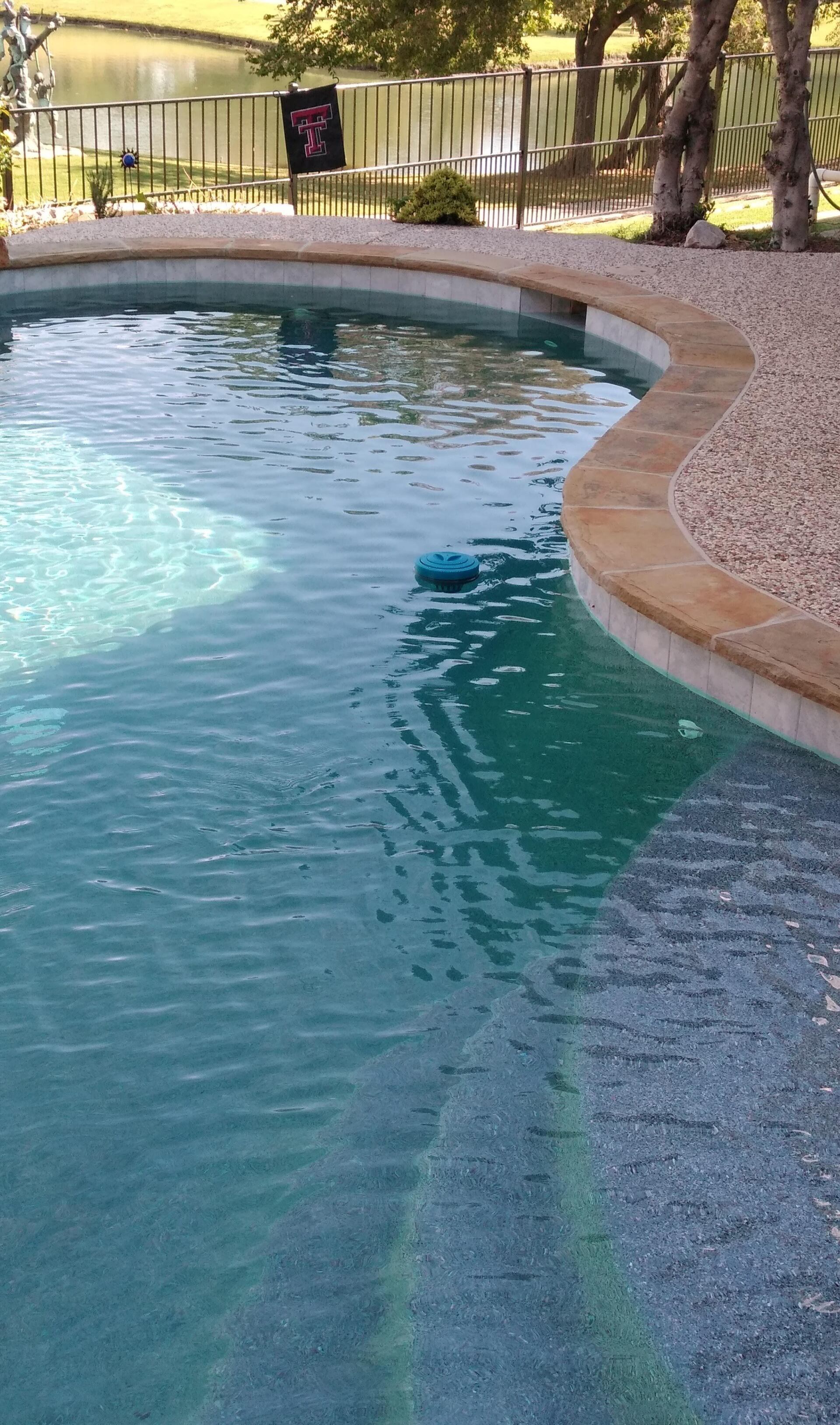 A swimming pool with a sign that says no diving