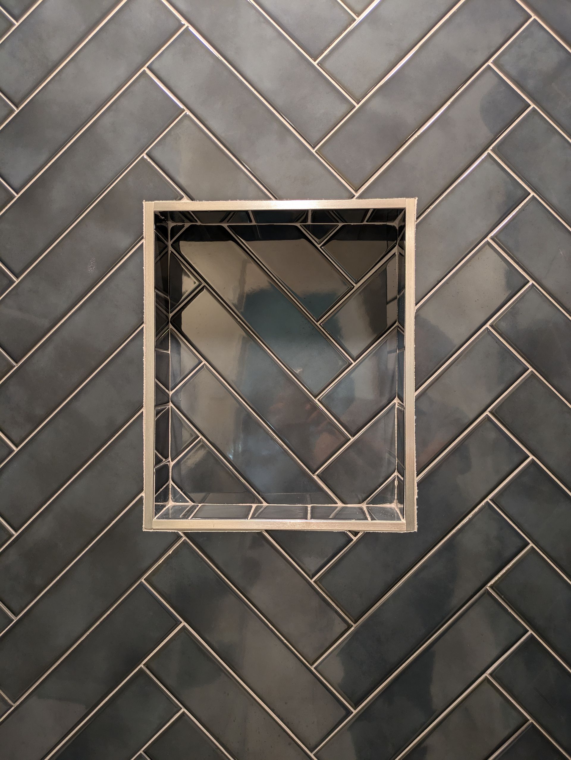 A square window in a herringbone patterned wall