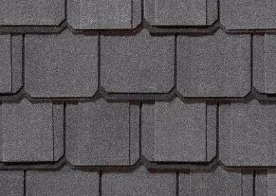 Dark gray asphalt shingles in a repeating pattern.