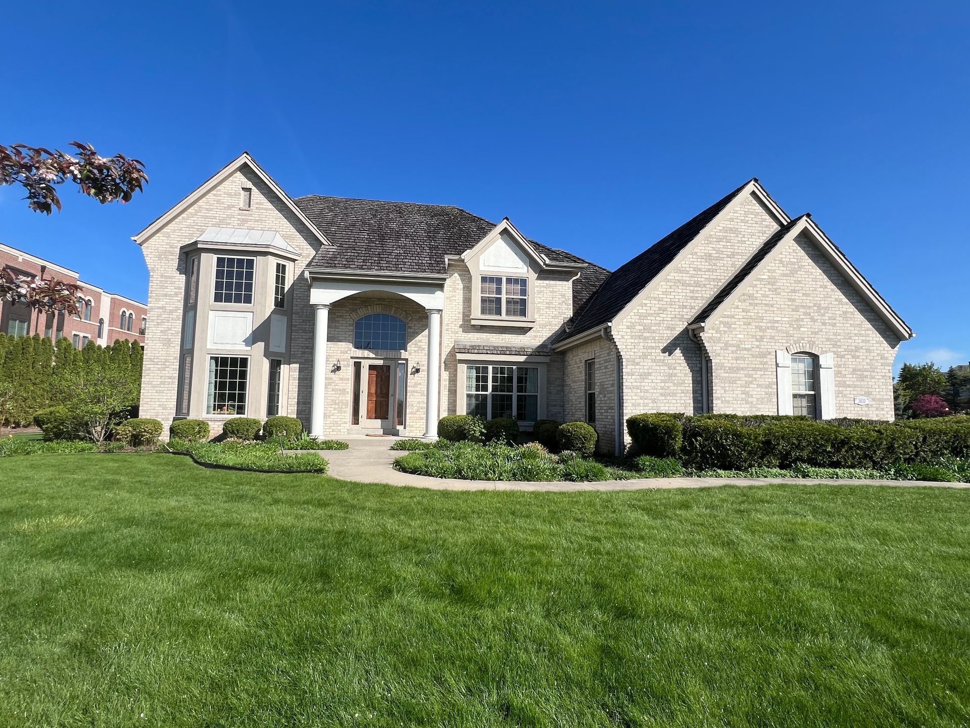 Paint roller and tray, paint can, and brush on floor; for painting.