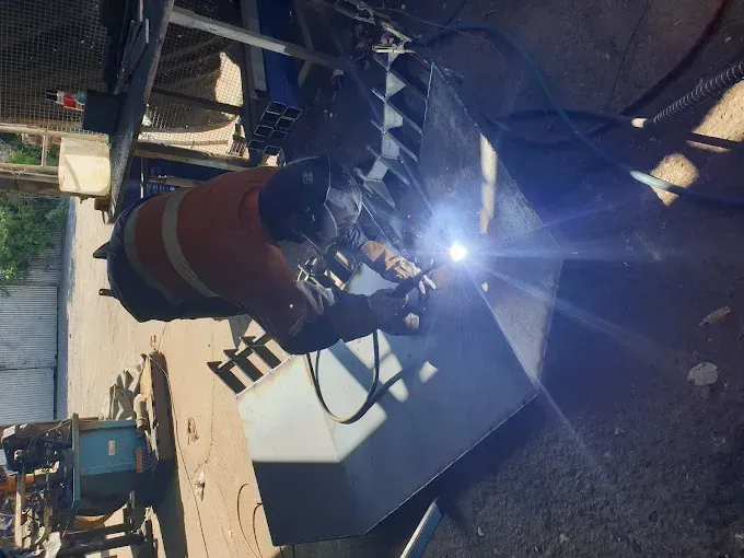Man in Black Coat and Hat Inspecting a Semi-truck Engine — RCM Diesel & Hydraulic Services in West Rockhampton, QLD