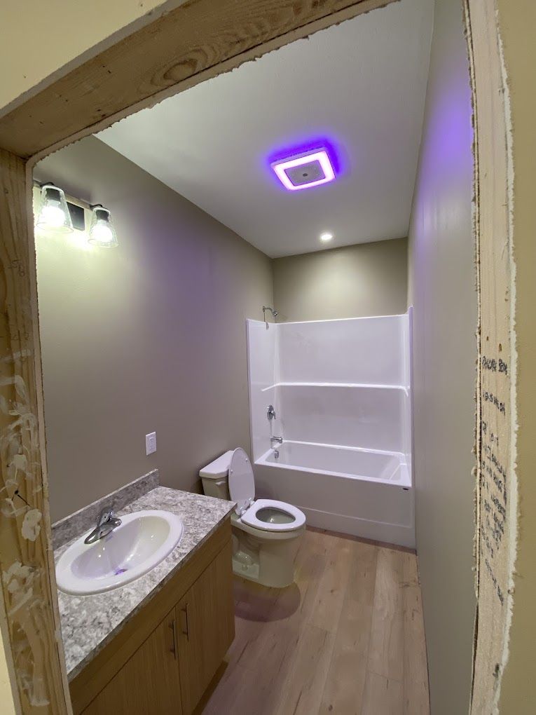 A bathroom with a toilet , sink , tub and shower.