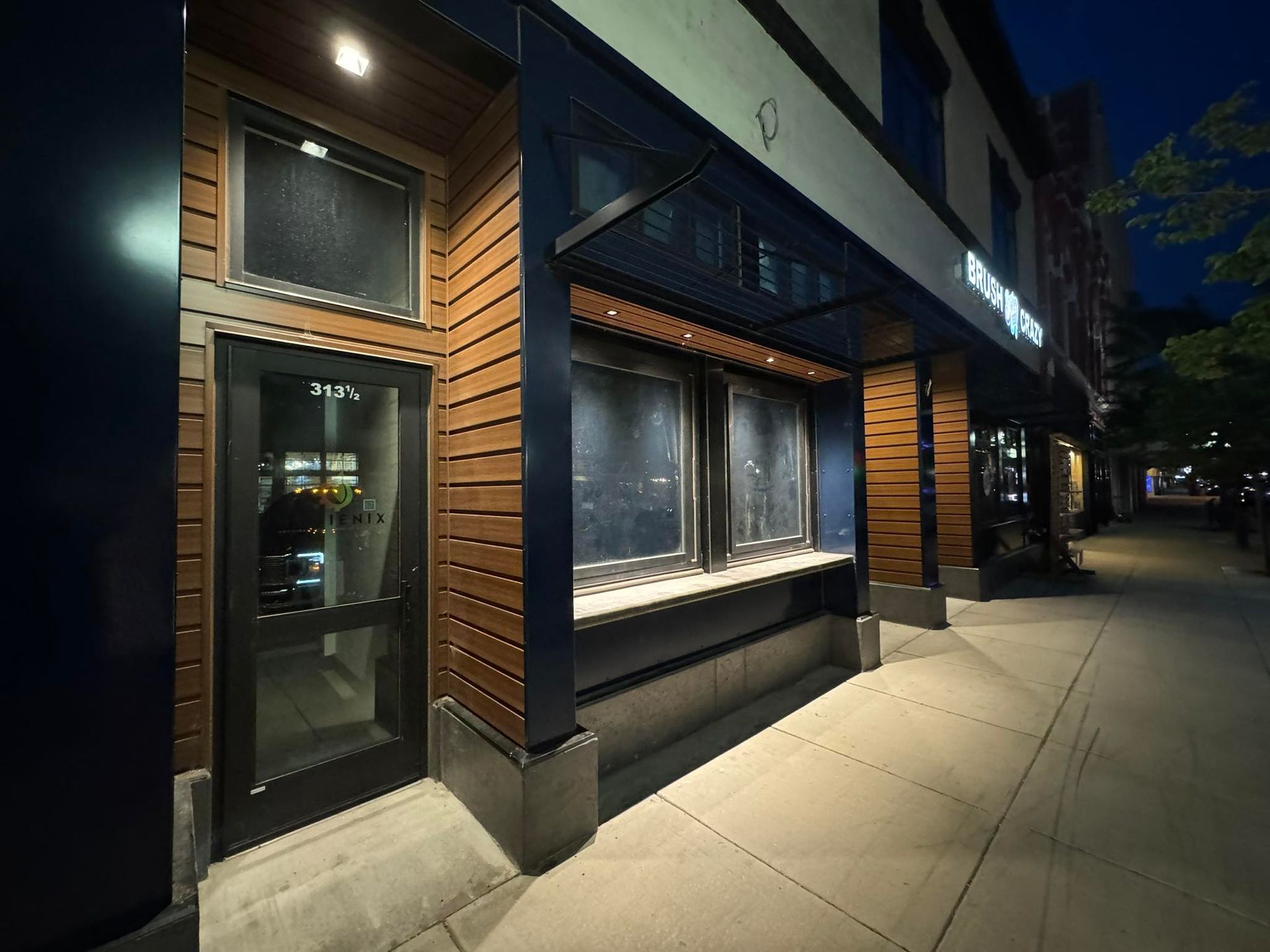 A building with a glass door and a sign that says ' a ' on it