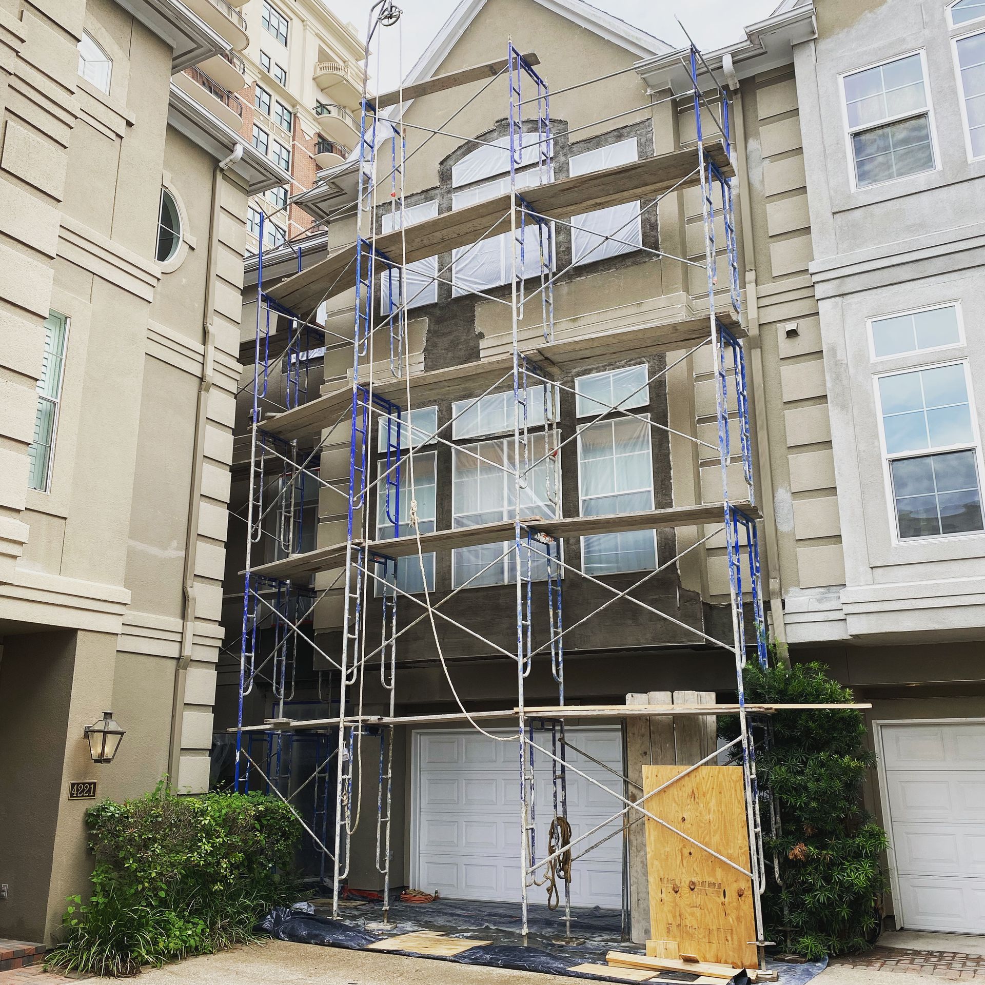 A building with scaffolding on it is being painted.