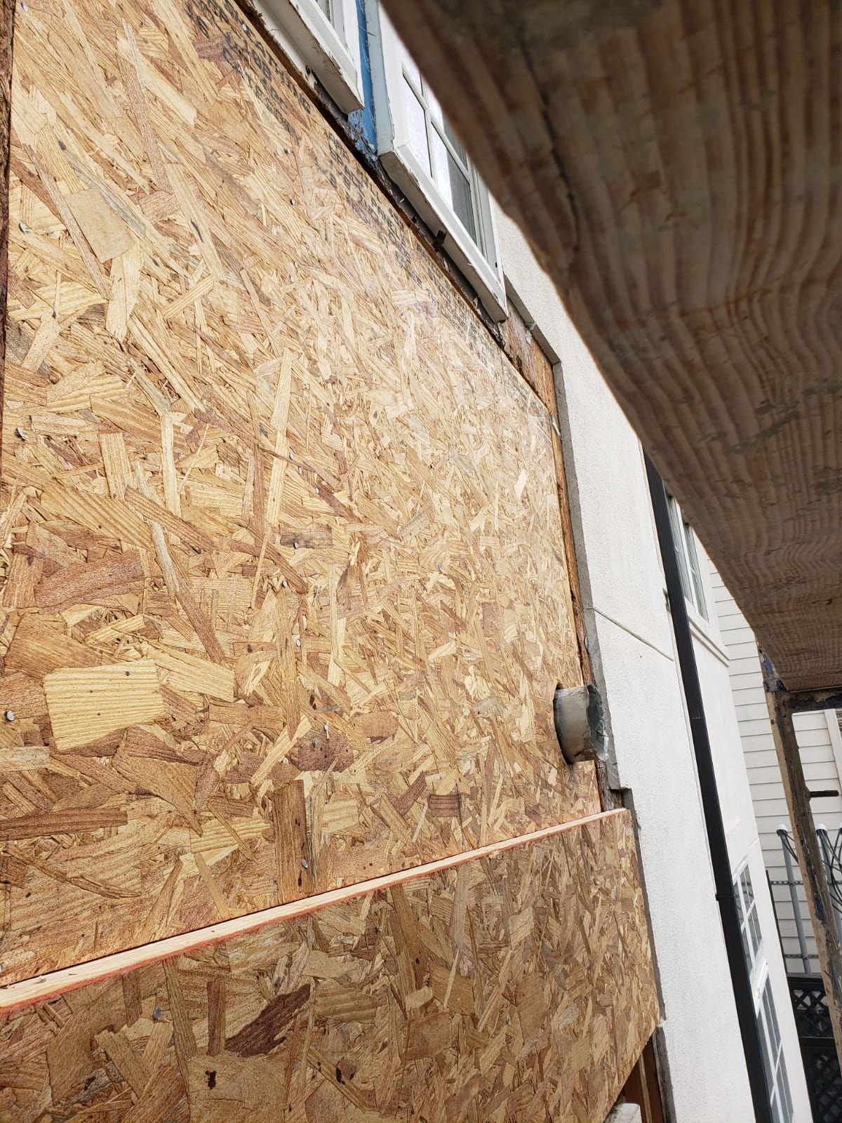 A building with a lot of plywood on the side of it.