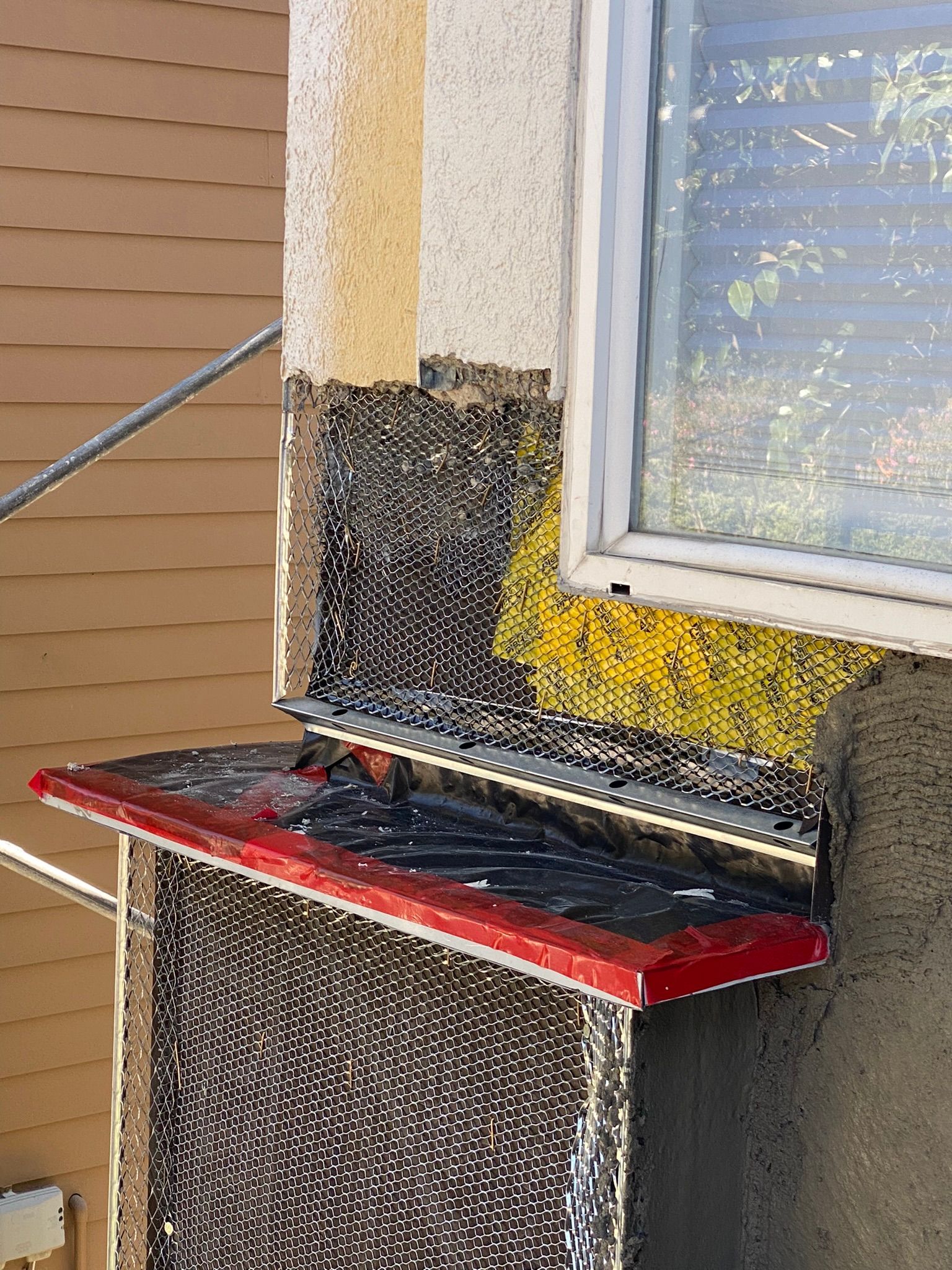 A window is being installed on the side of a building.