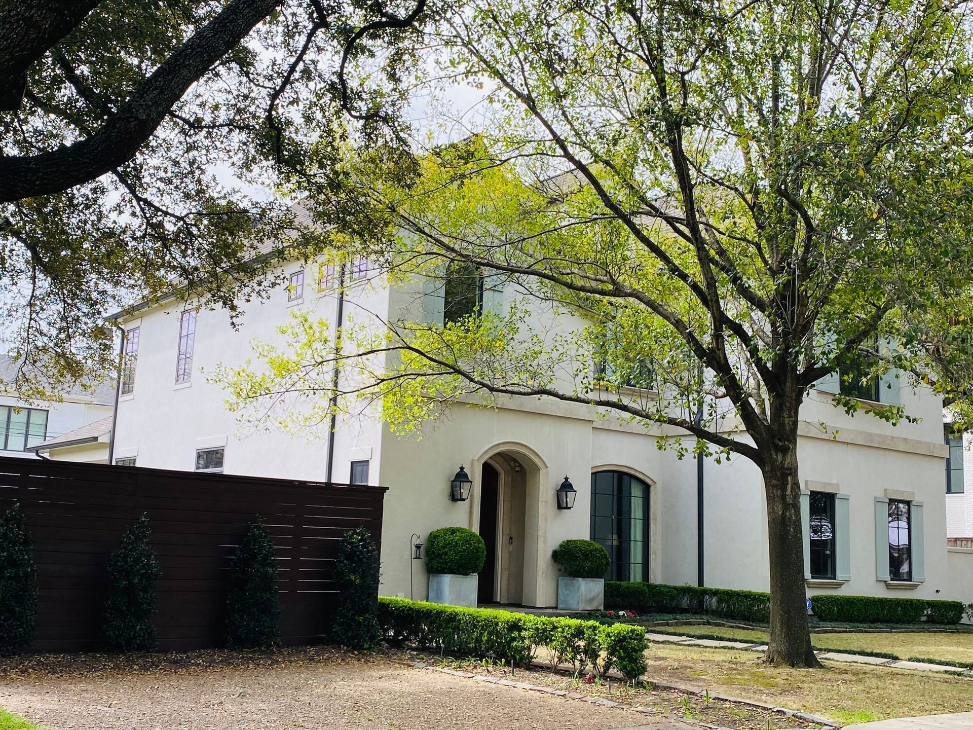 A white house with a tree in front of it