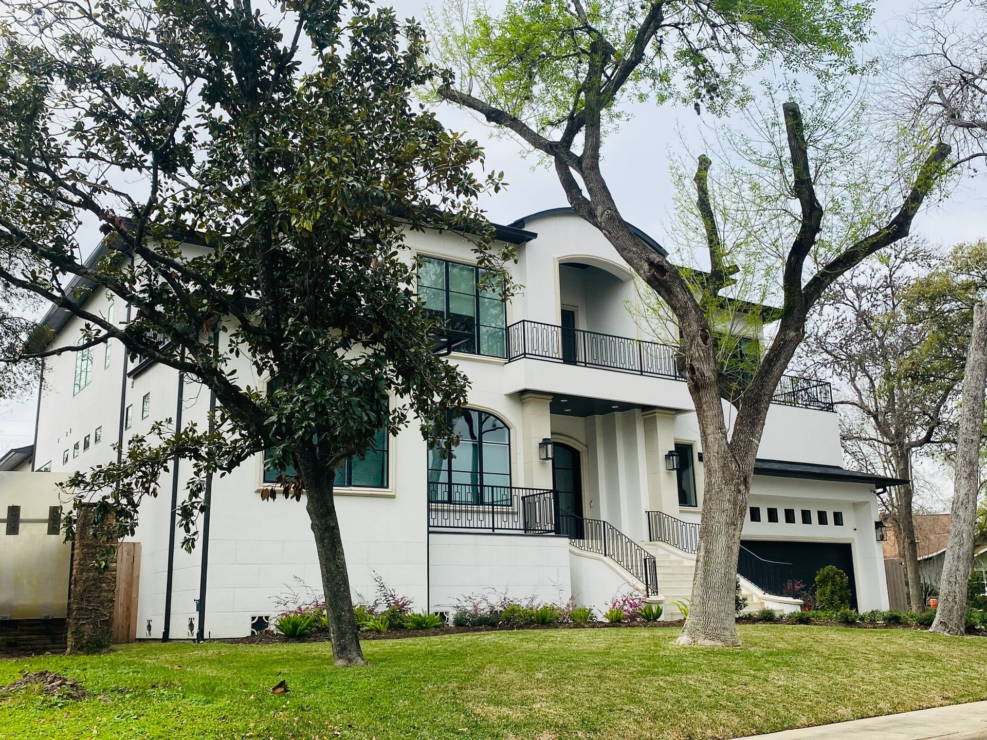 A large white house with trees in front of it